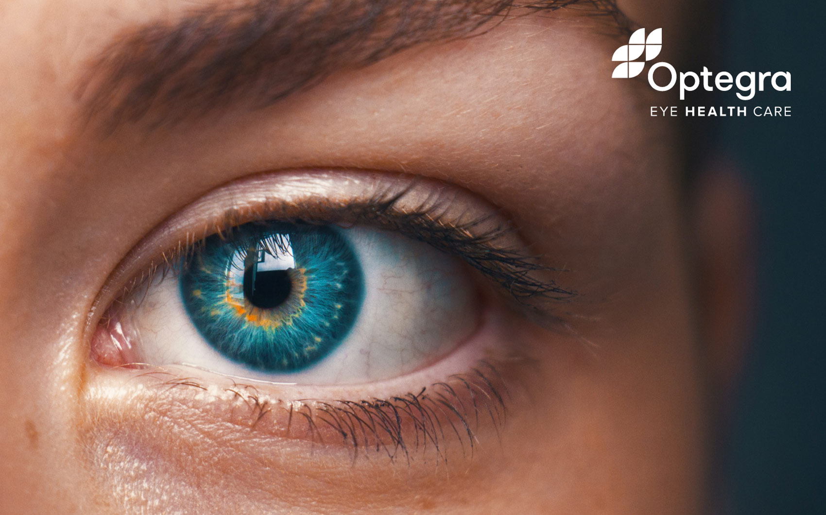 Close-up of female eye with logo