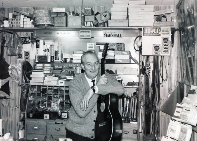 Founder Harry Anderton, holding guitar