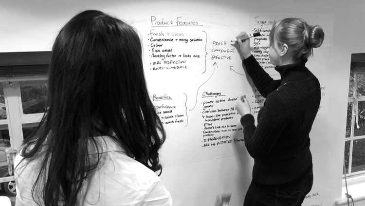 Team brainstorm on whiteboard