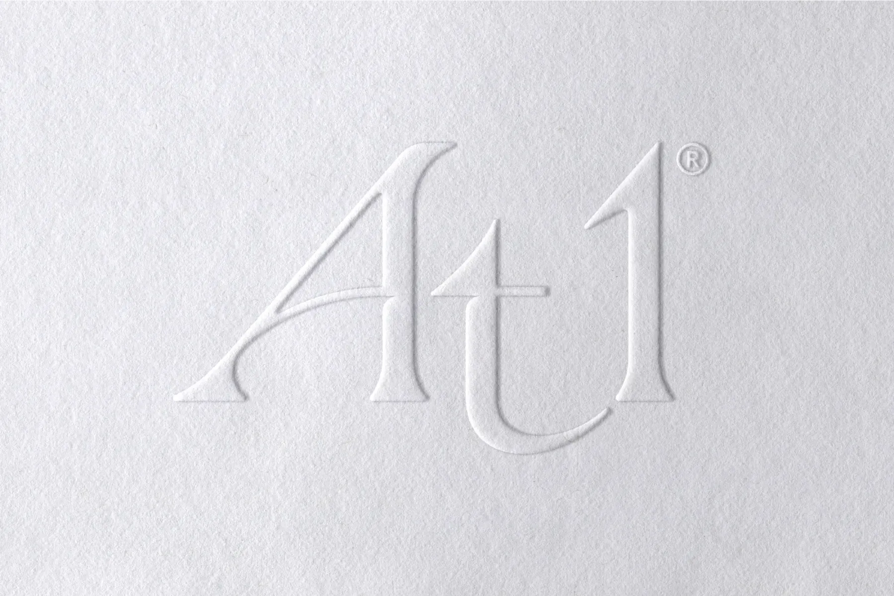 At1 logo embossed in to a white background