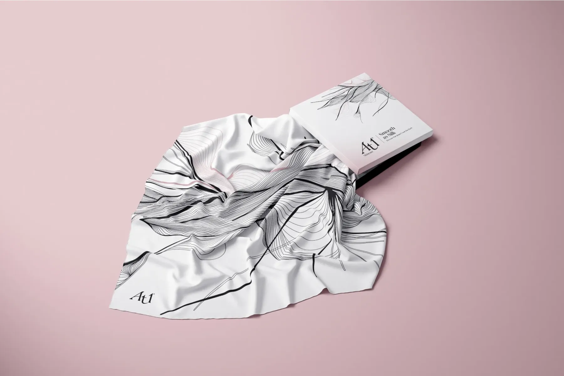 A scarf pulled partially out of the square packaging