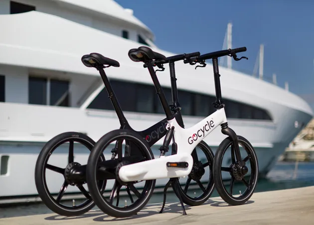 Gocycle alongisde luxury yacht