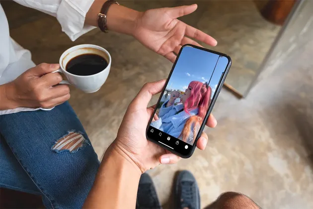 Phone in hand watching Carmex social video